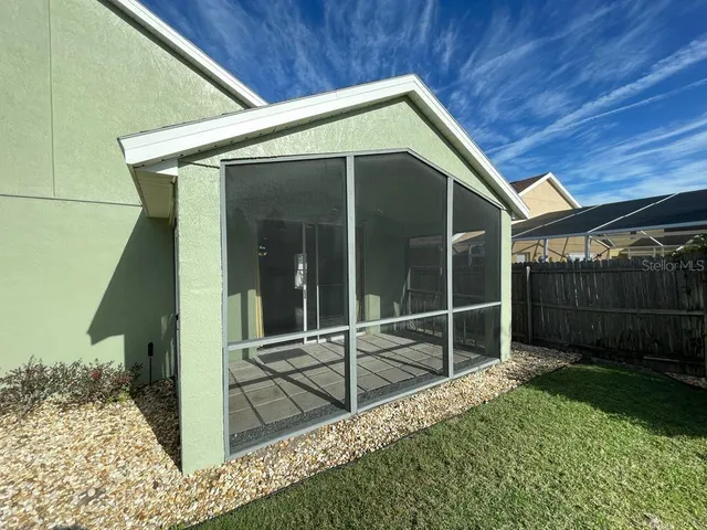 a view of a house with a backyard