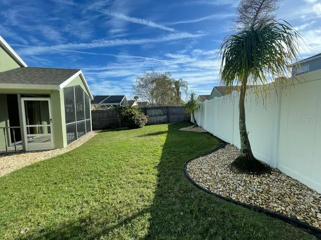 a view of a house with a backyard