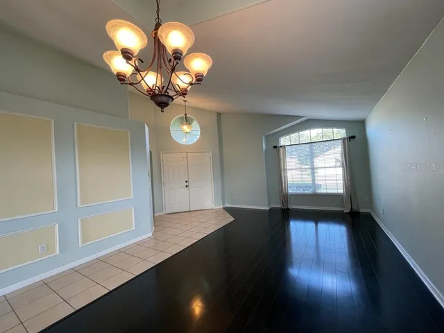 a view of a room with wooden floor