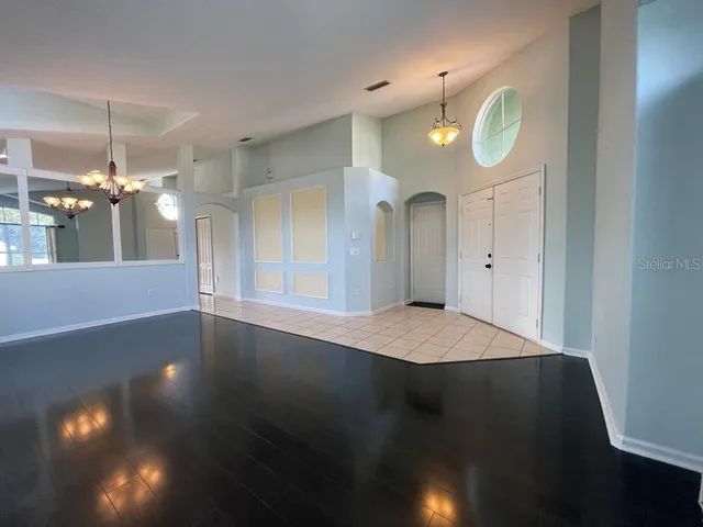 a view of a chandelier fan and wooden floor