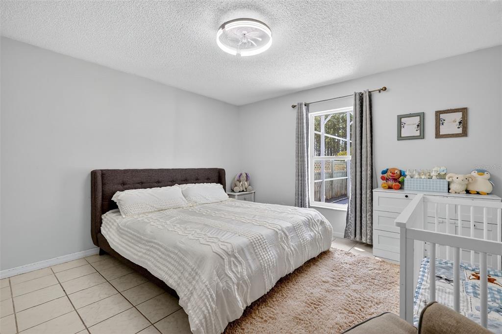 14520 Lost Lake Road Clermont, FL 34711 - Photo 24 of 47 a bedroom with a bed and window