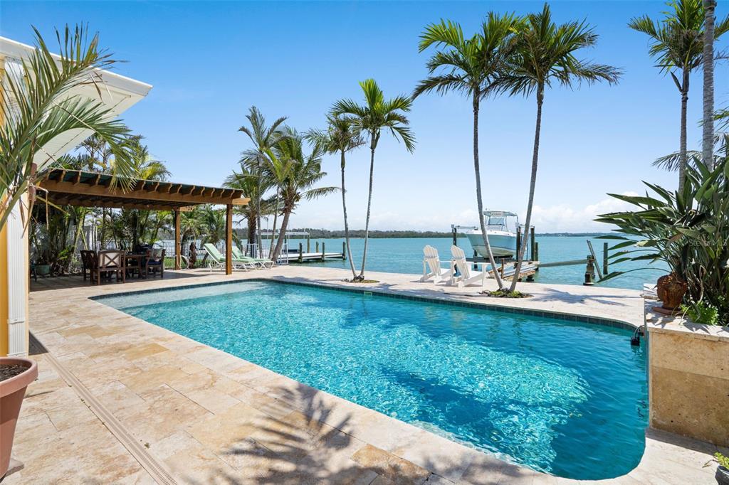 a view of a swimming pool and a longer chairs
