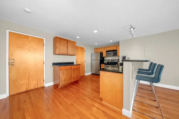 a kitchen with stainless steel appliances granite countertop a refrigerator and microwave