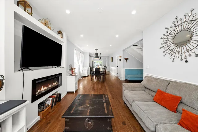 a dining room with furniture and wooden floor
