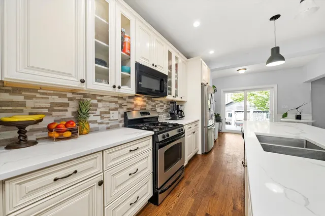 a kitchen with stainless steel appliances granite countertop lots of counter top space and cabinets