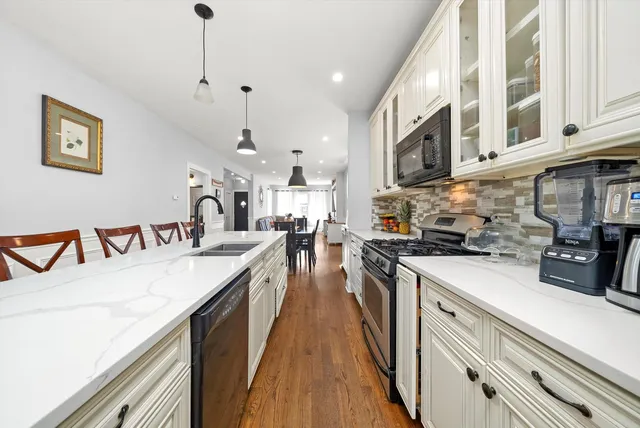 a large kitchen with stainless steel appliances lots of counter space