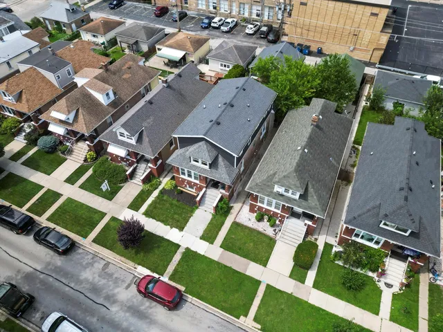 an aerial view of multiple houses with yard