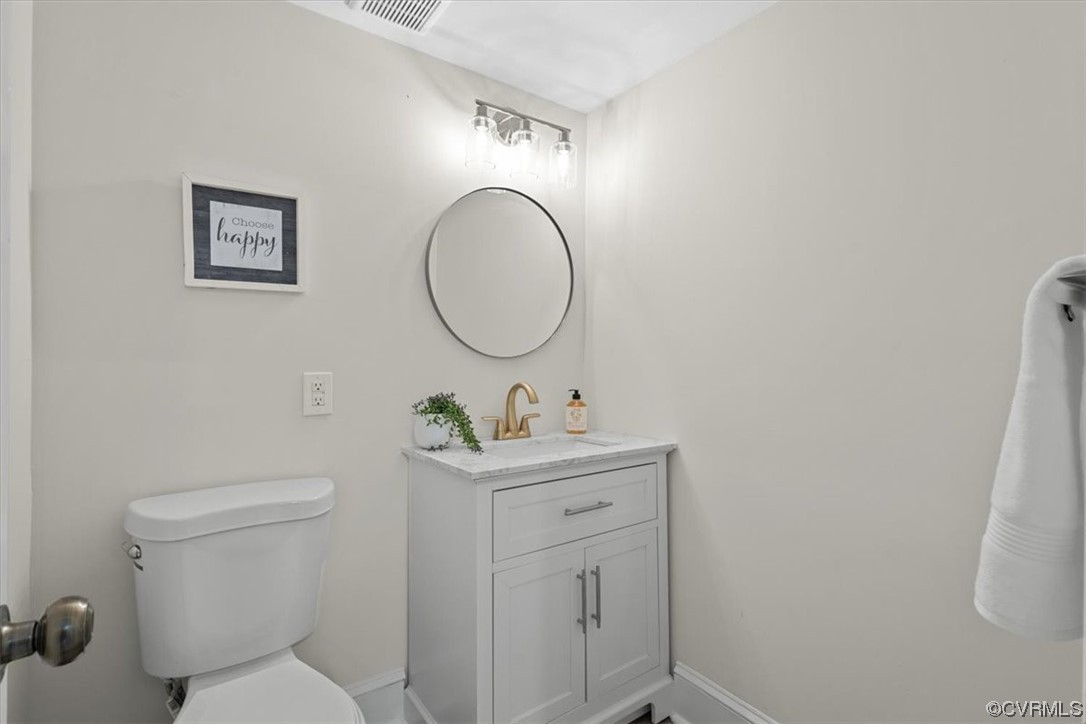 9349 Cardiff Loop Road North Chesterfield, VA 23236 - Photo 40 of 50 a bathroom with a toilet a sink and mirror
