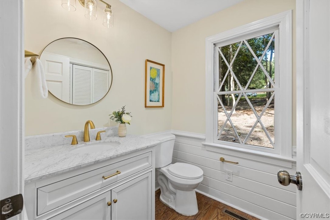 9349 Cardiff Loop Road North Chesterfield, VA 23236 - Photo 9 of 50 a bathroom with a toilet a sink a mirror and a window