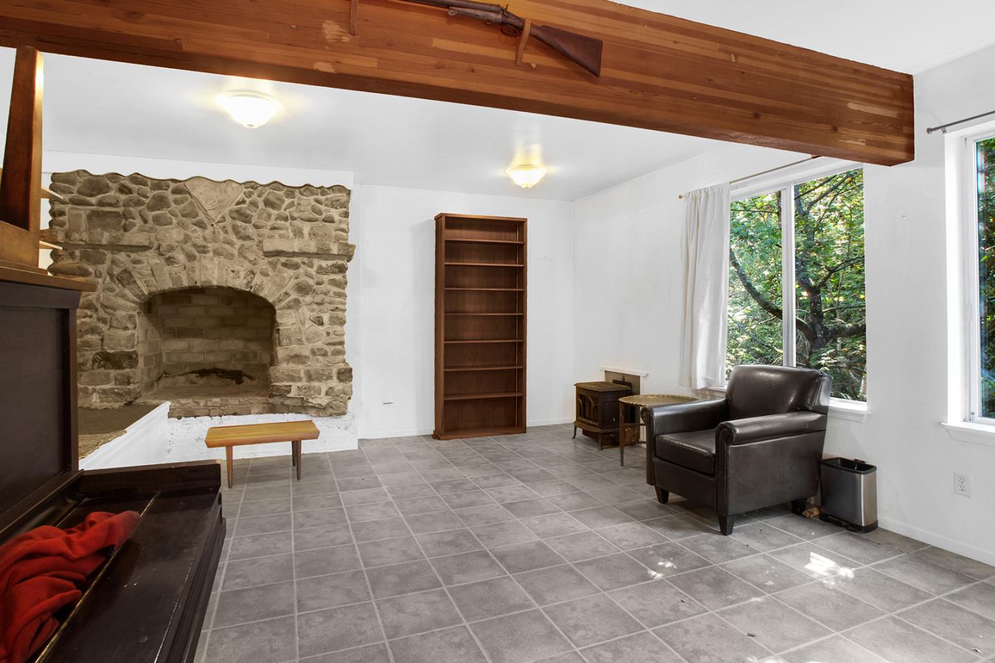 176 Roquena Drive La Honda, CA 94020 - Photo 12 of 21 a living room with furniture and a fireplace