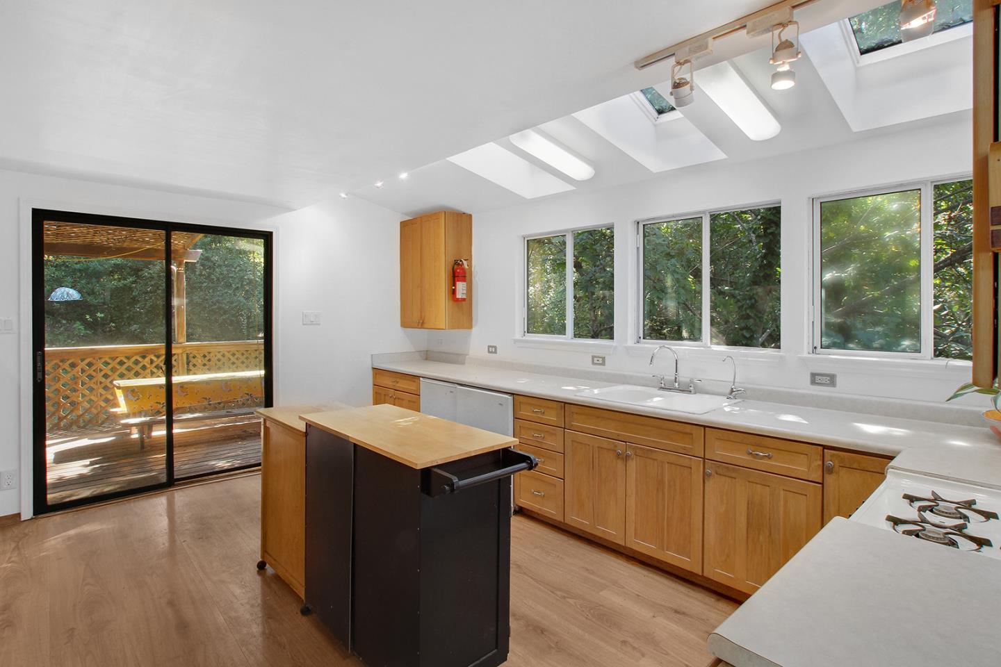 176 Roquena Drive La Honda, CA 94020 - Photo 4 of 21 a large kitchen with kitchen island a large window cabinets a sink and stainless steel appliances