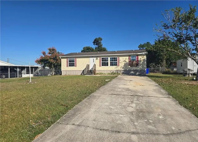 a front view of house with yard and green space