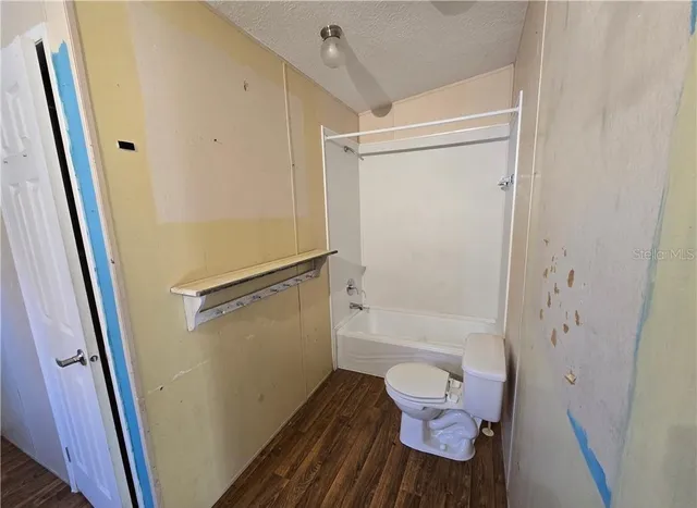 a bathroom with a shower and a toilet