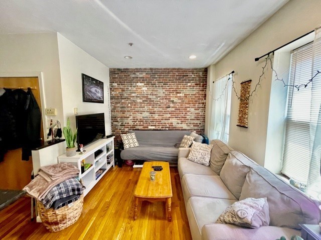 17 Thacher Street, Unit 3 Boston, MA 02113 - Photo 4 of 24 a living room with furniture fireplace and flat screen tv