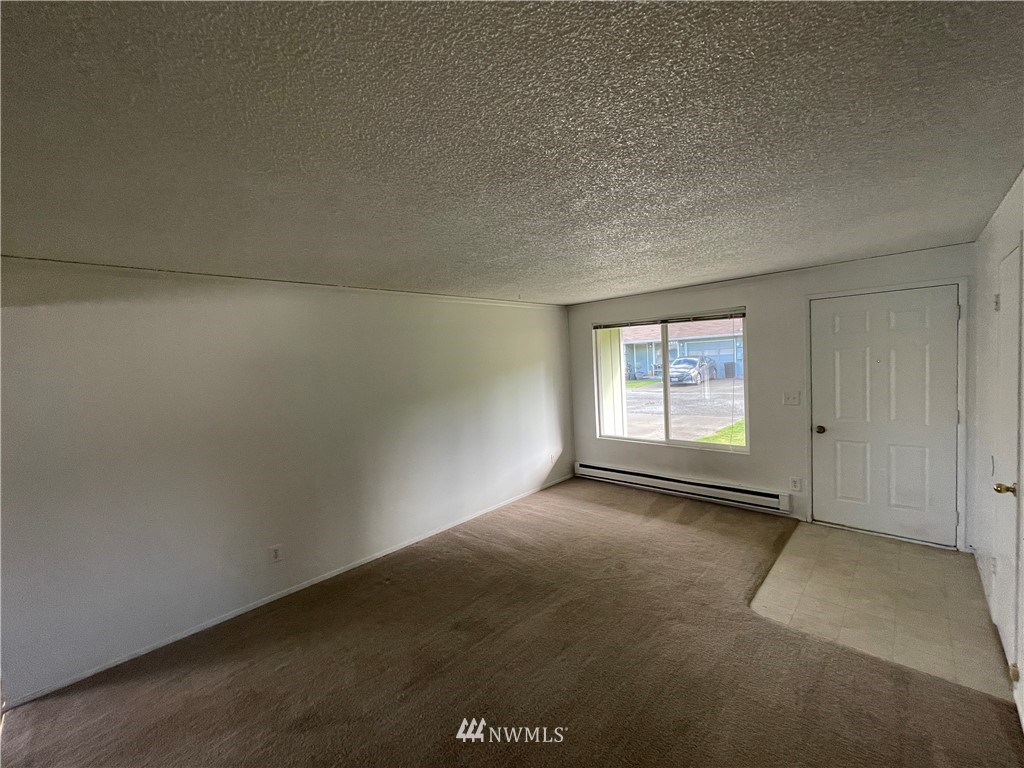 18404 Albany Street Southwest, Unit A & D Rochester, WA 98579 - Photo 14 of 19 an empty room with windows