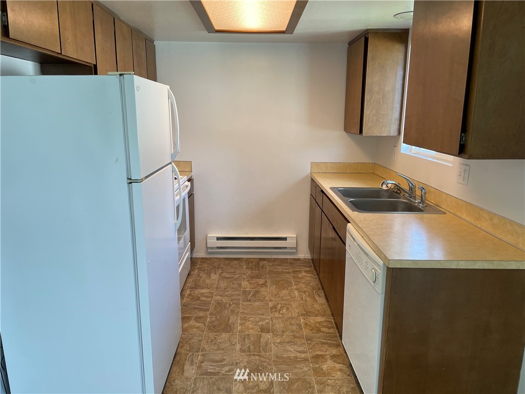 18404 Albany Street Southwest, Unit A & D Rochester, WA 98579 - Photo 17 of 19 a kitchen with a refrigerator and a sink