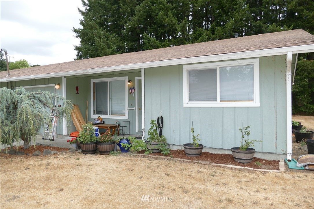 18404 Albany Street Southwest, Unit A & D Rochester, WA 98579 - Photo 5 of 19 a view of a house with backyard sitting area and porch