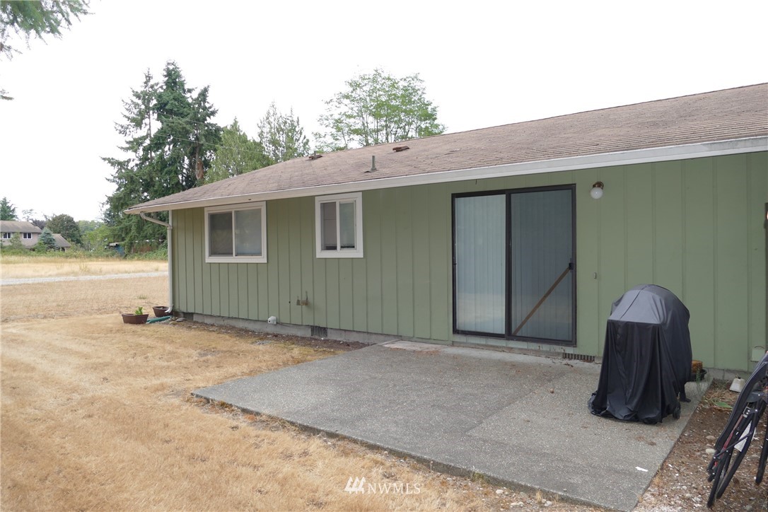18404 Albany Street Southwest, Unit A & D Rochester, WA 98579 - Photo 8 of 19 a backyard of a house with yard and outdoor seating