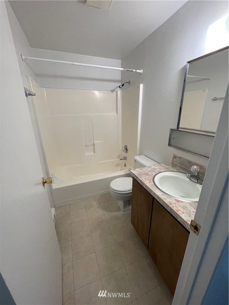 18404 Albany Street Southwest, Unit A & D Rochester, WA 98579 - Photo 10 of 19 a bathroom with a granite countertop sink toilet and shower