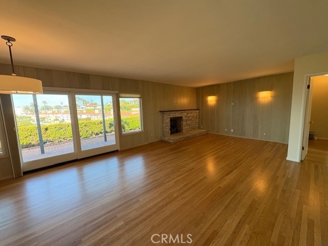 205 Pso De Suenos Redondo Beach, CA 90277 - Photo 15 of 34 a view of empty room with wooden floor and fireplace
