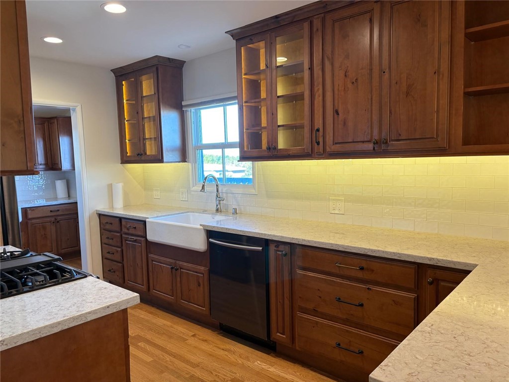 205 Pso De Suenos Redondo Beach, CA 90277 - Photo 21 of 34 a kitchen with a sink and a stove top oven with wooden floor