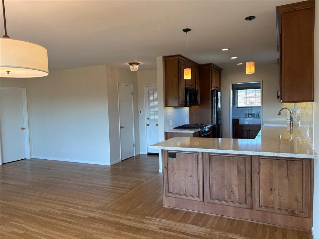 205 Pso De Suenos Redondo Beach, CA 90277 - Photo 22 of 34 a living room with kitchen island furniture and a wooden floor