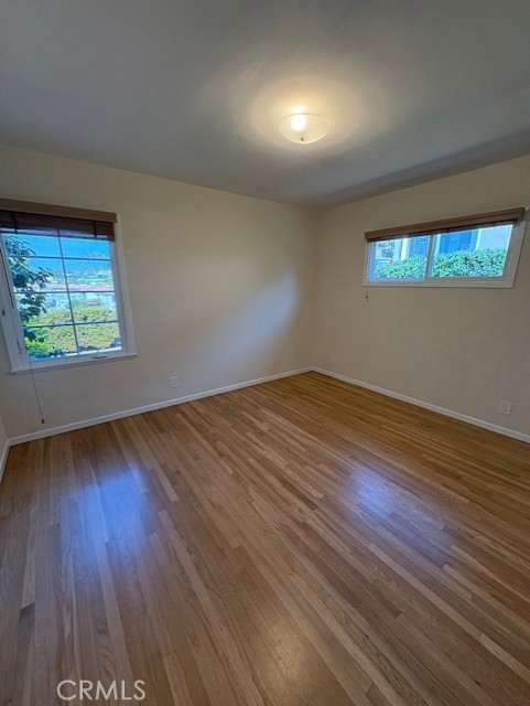 205 Pso De Suenos Redondo Beach, CA 90277 - Photo 30 of 34 an empty room with wooden floor and windows