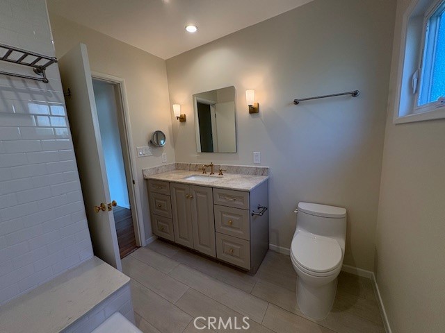 205 Pso De Suenos Redondo Beach, CA 90277 - Photo 33 of 34 a bathroom with a toilet a sink a mirror and vanity