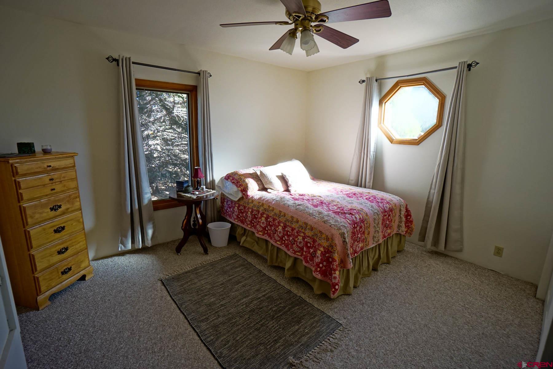 6733 2050th Road Delta, CO 81416 - Photo 13 of 32 a bedroom with a bed and a chandelier