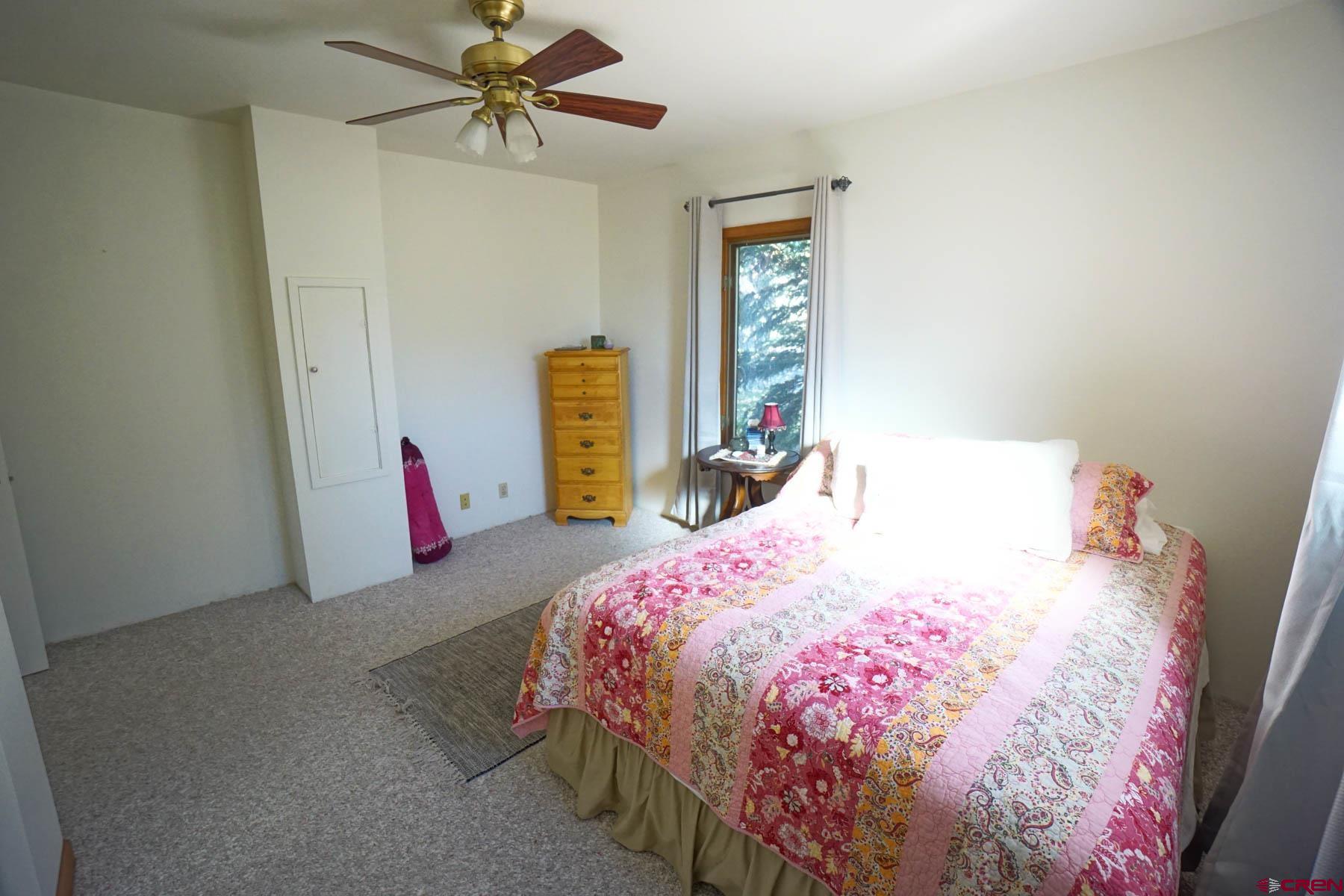 6733 2050th Road Delta, CO 81416 - Photo 14 of 32 a bedroom with a bed and a window