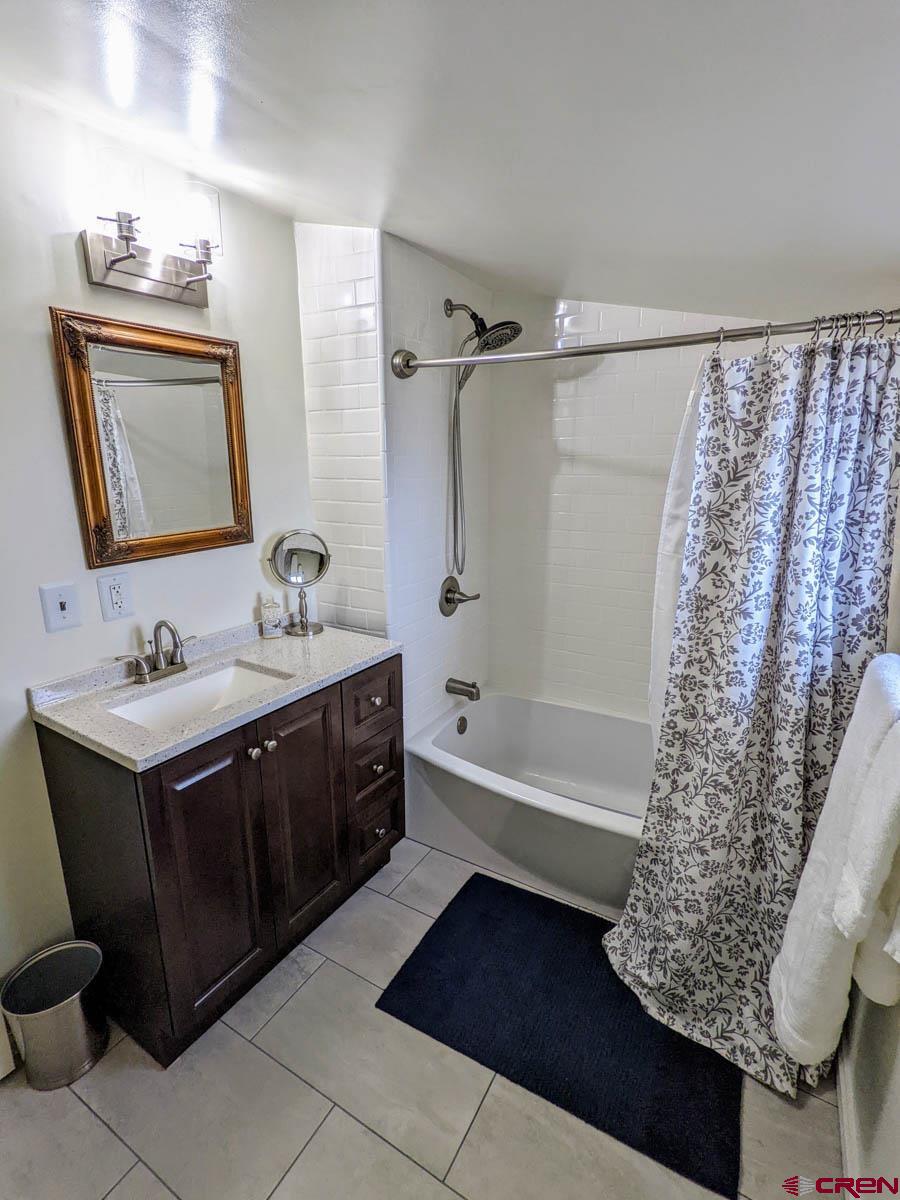6733 2050th Road Delta, CO 81416 - Photo 15 of 32 a bathroom with a double vanity sink toilet mirror and bathtub