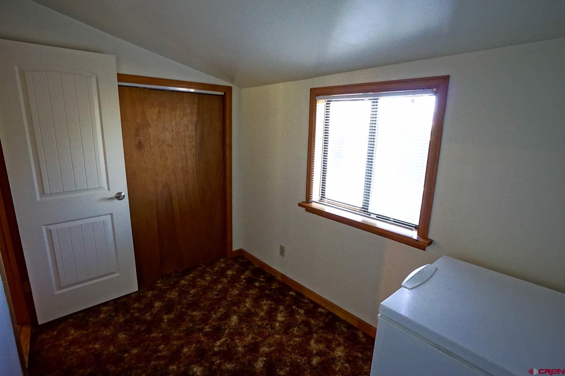 6733 2050th Road Delta, CO 81416 - Photo 18 of 32 a bedroom with a bed and a window