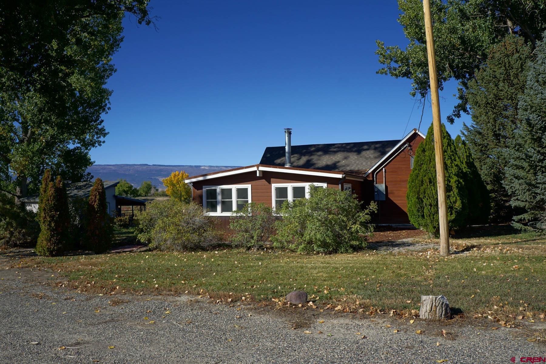 6733 2050th Road Delta, CO 81416 - Photo 19 of 32 a front view of a house with a yard