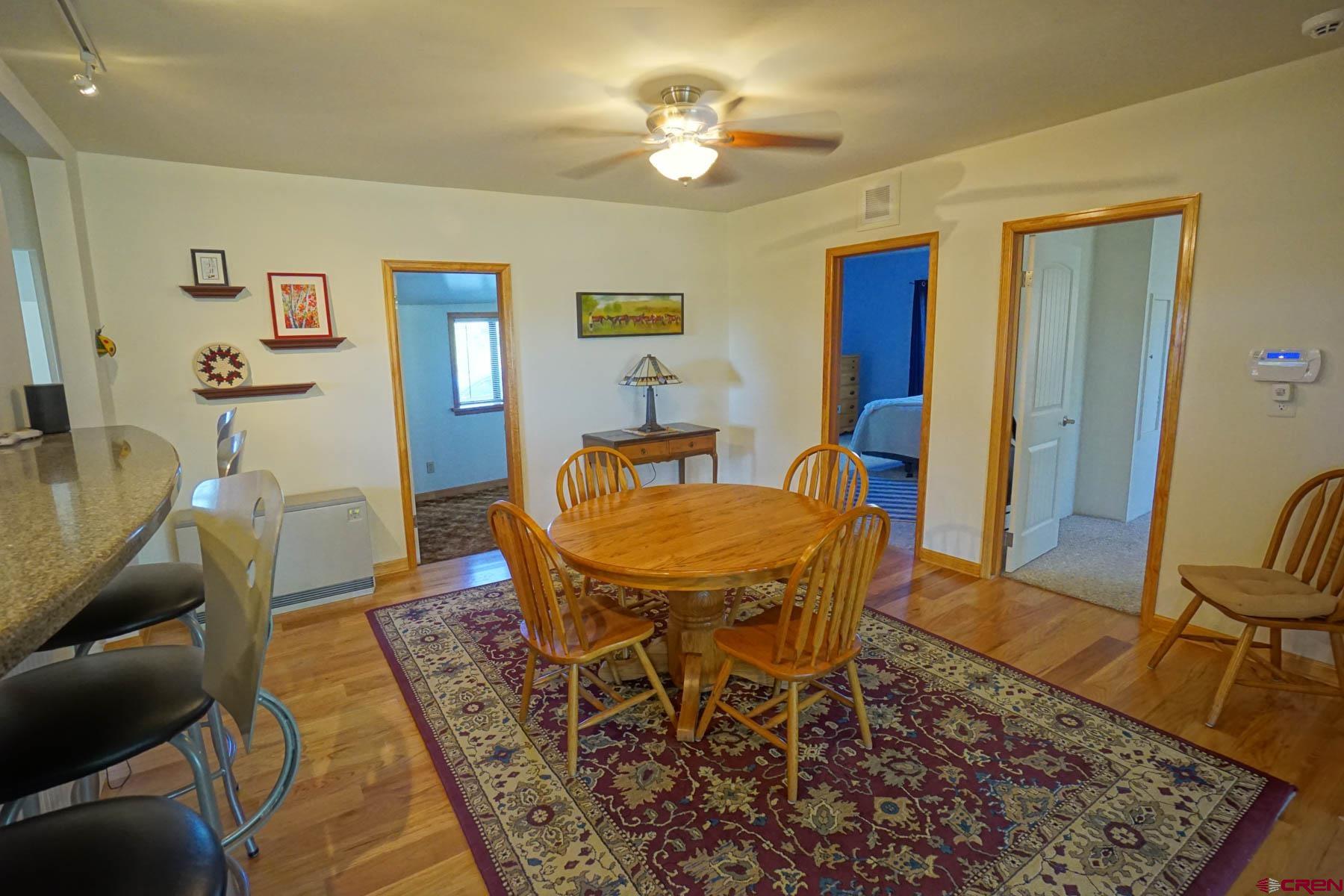 6733 2050th Road Delta, CO 81416 - Photo 4 of 32 a dining room with furniture a rug and a chandelier