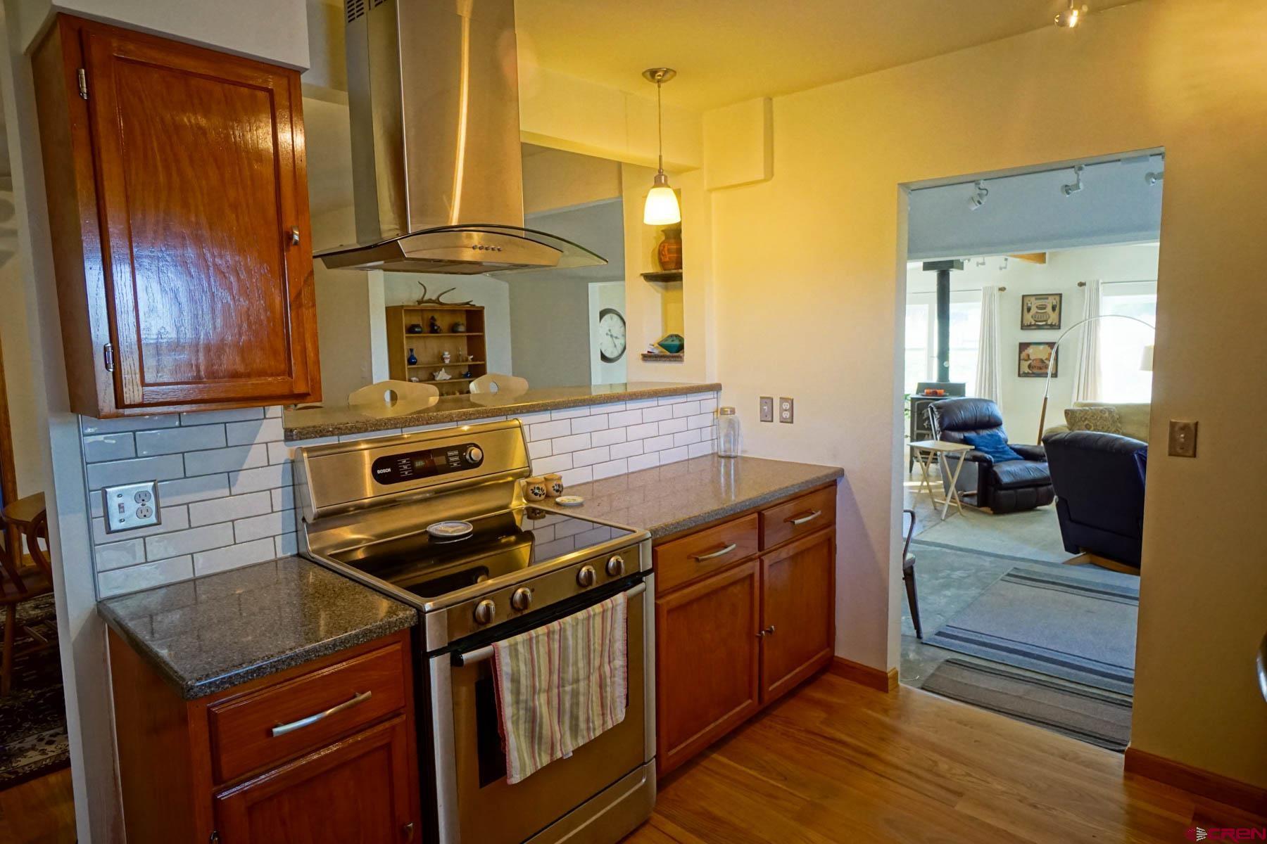 6733 2050th Road Delta, CO 81416 - Photo 6 of 32 a kitchen with stainless steel appliances granite countertop a stove a sink and a refrigerator