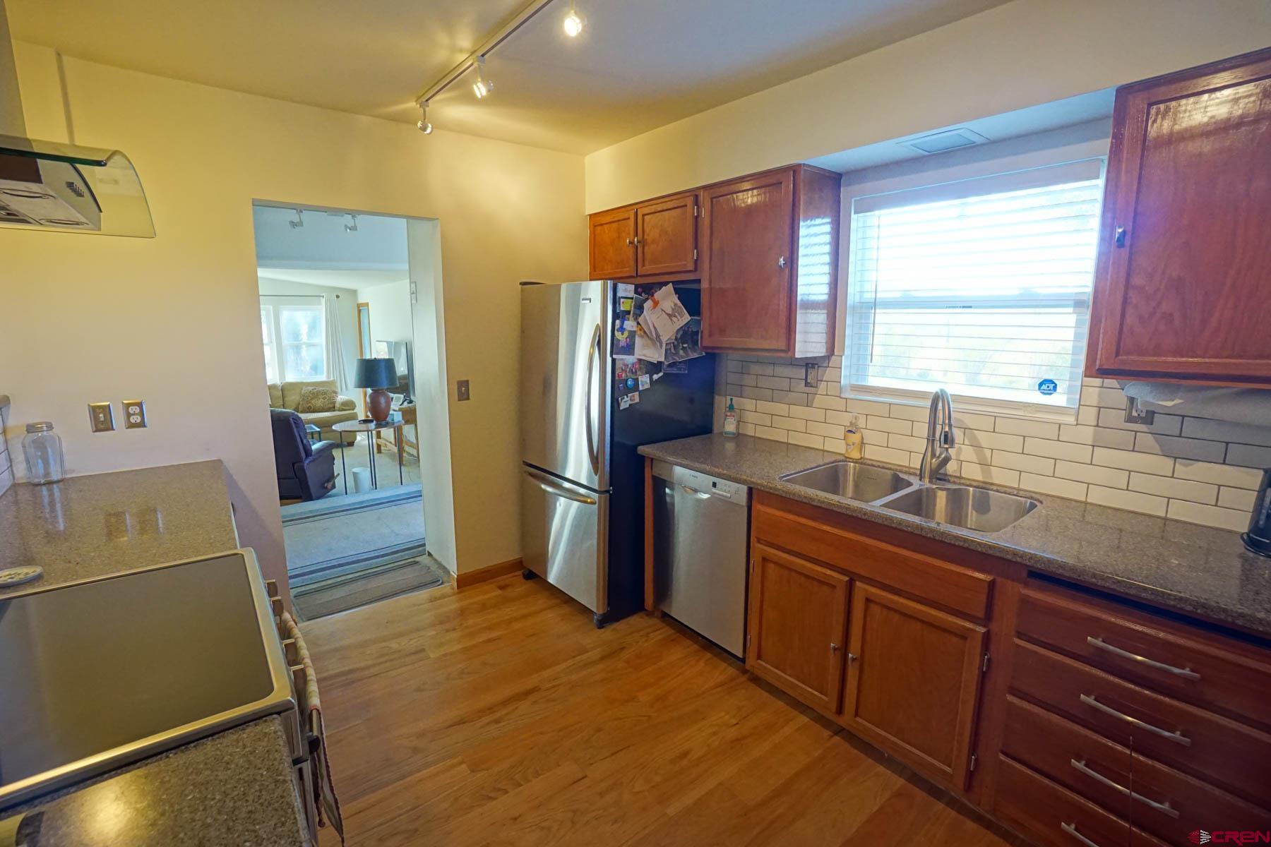 6733 2050th Road Delta, CO 81416 - Photo 7 of 32 a kitchen with a sink refrigerator and microwave