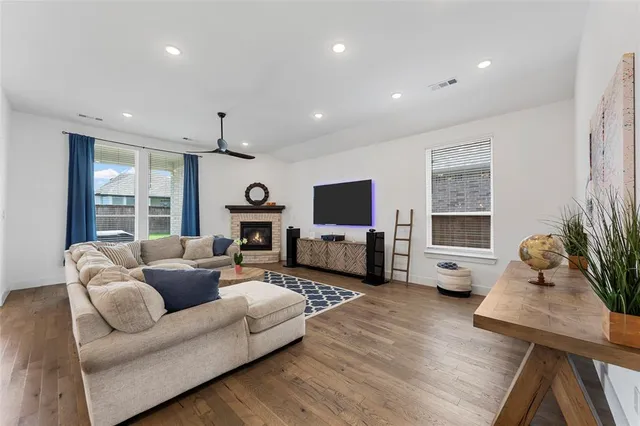 a living room with fireplace furniture and a fireplace