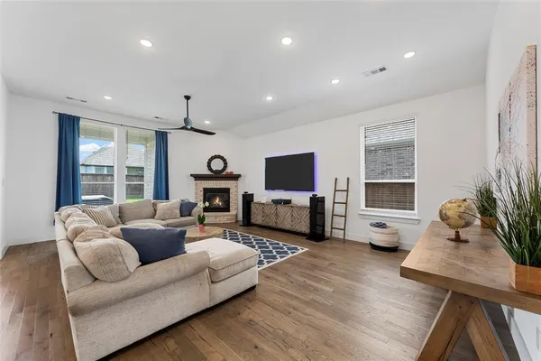 a living room with fireplace furniture and a fireplace