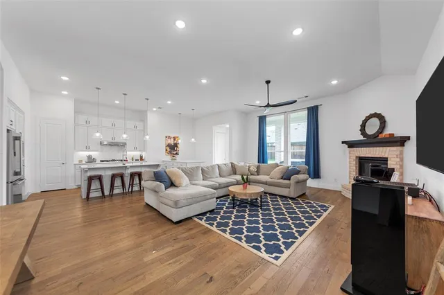 a kitchen with kitchen island granite countertop a sink and white cabinets