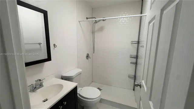 an empty room with wooden floor and a window