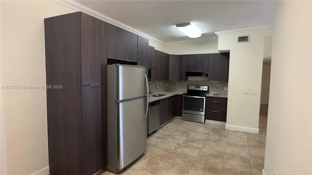 a kitchen with stainless steel appliances granite countertop a refrigerator and a sink