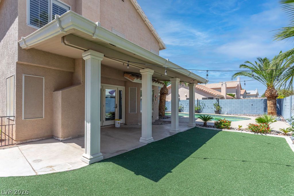 1416 Walstone Road North Las Vegas, NV 89031 - Photo 43 of 47 A spacious backyard retreat features a private pool, covered patio, and lush artificial turf.