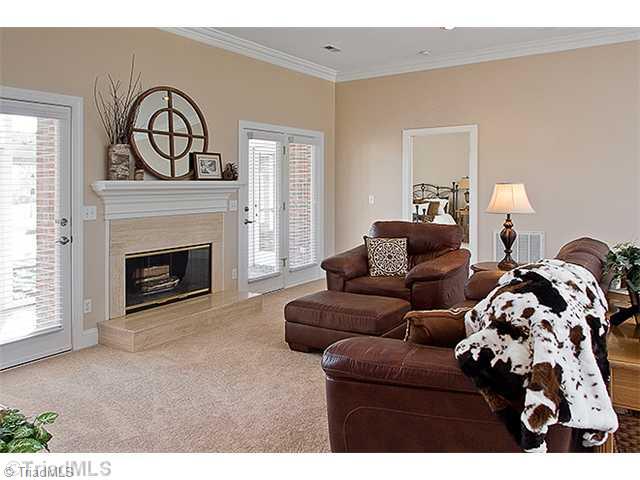 1031 Sutton Road Greensboro, NC 27406 - Photo 16 of 16 Den/Family/Great Room. Spacious Great Room offers new carpet, new interior paint, all neutual colors, fireplace, with French doors accessing screen porch area, great open floorplan