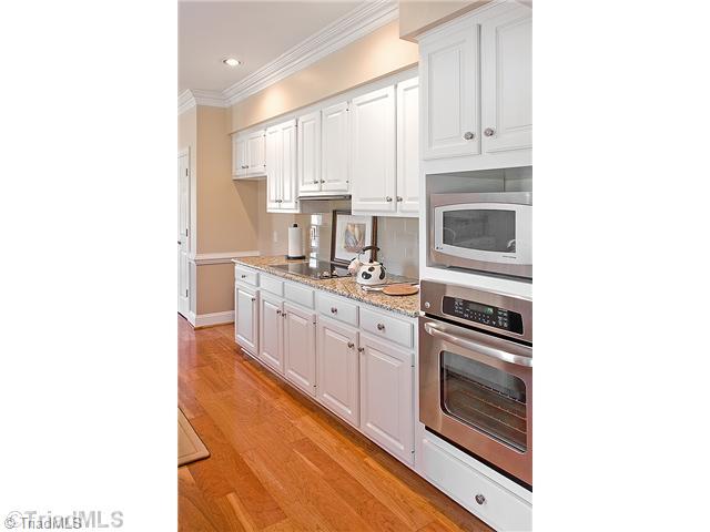 1031 Sutton Road Greensboro, NC 27406 - Photo 2 of 16 Kitchen. You will love the new updated kitchen, with new ss appliances, granite counter tops, tile, backsplash, beautiful hardwood floors, what a great home to move right in to. The kitchen offers and large island, pantry, and great windows for natural light