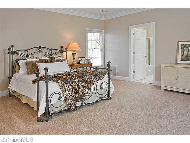 1031 Sutton Road Greensboro, NC 27406 - Photo 5 of 16 Master Bedroom. Spacious master suite accessing porch. The home feels like almost new. You will find new neutral carpet, new interior paint and new hardware. The home offers lovely moldings throughout.