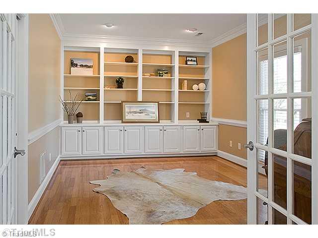 1031 Sutton Road Greensboro, NC 27406 - Photo 8 of 16 3rd Bedroom. Bedroom 3 is currently used as a library/office. You will love the beautiful hardwood floors, the room does offer a closet, lovely French doors and moldings.
