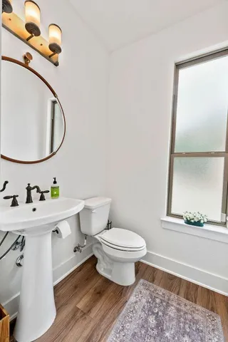 a view of kitchen island wooden floor center island and stainless steel appliances
