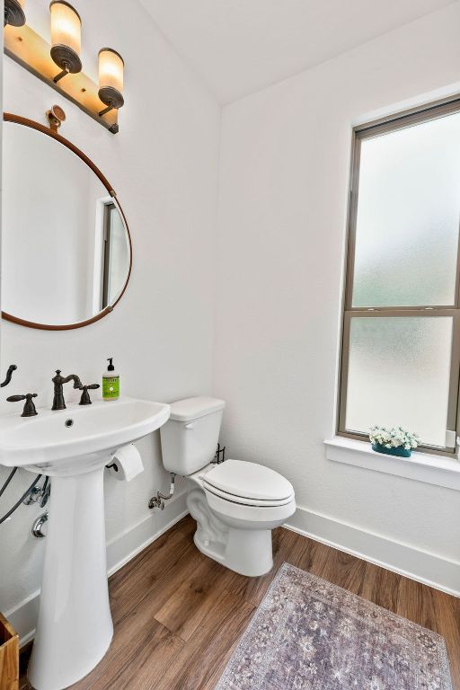213 Lets Roll Drive Fischer, TX 78623 - Photo 11 of 38 Half bathroom with baseboards, toilet, wood finished floors, and a sink