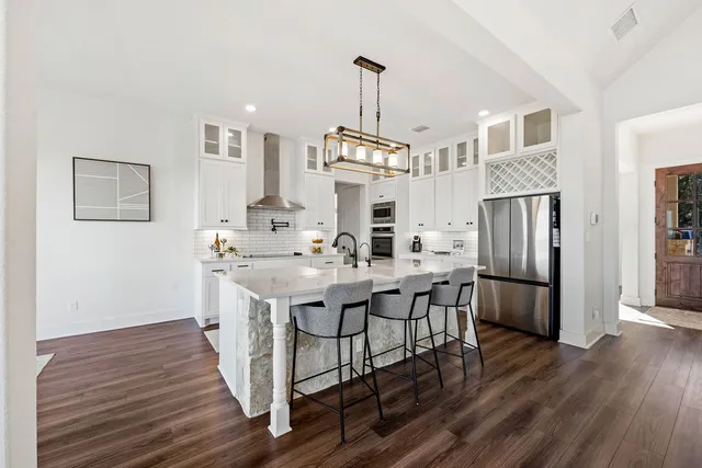 a kitchen with sink cabinets and wooden floor