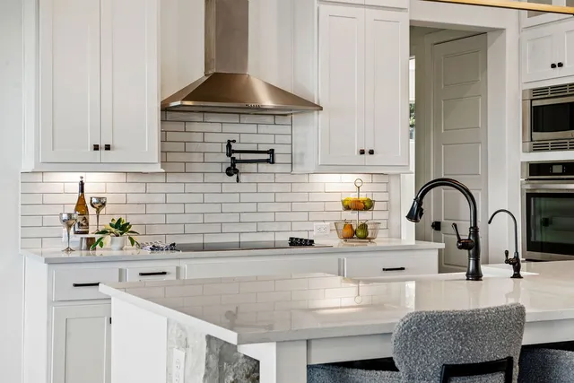 a kitchen with stainless steel appliances kitchen island granite countertop a sink and cabinets
